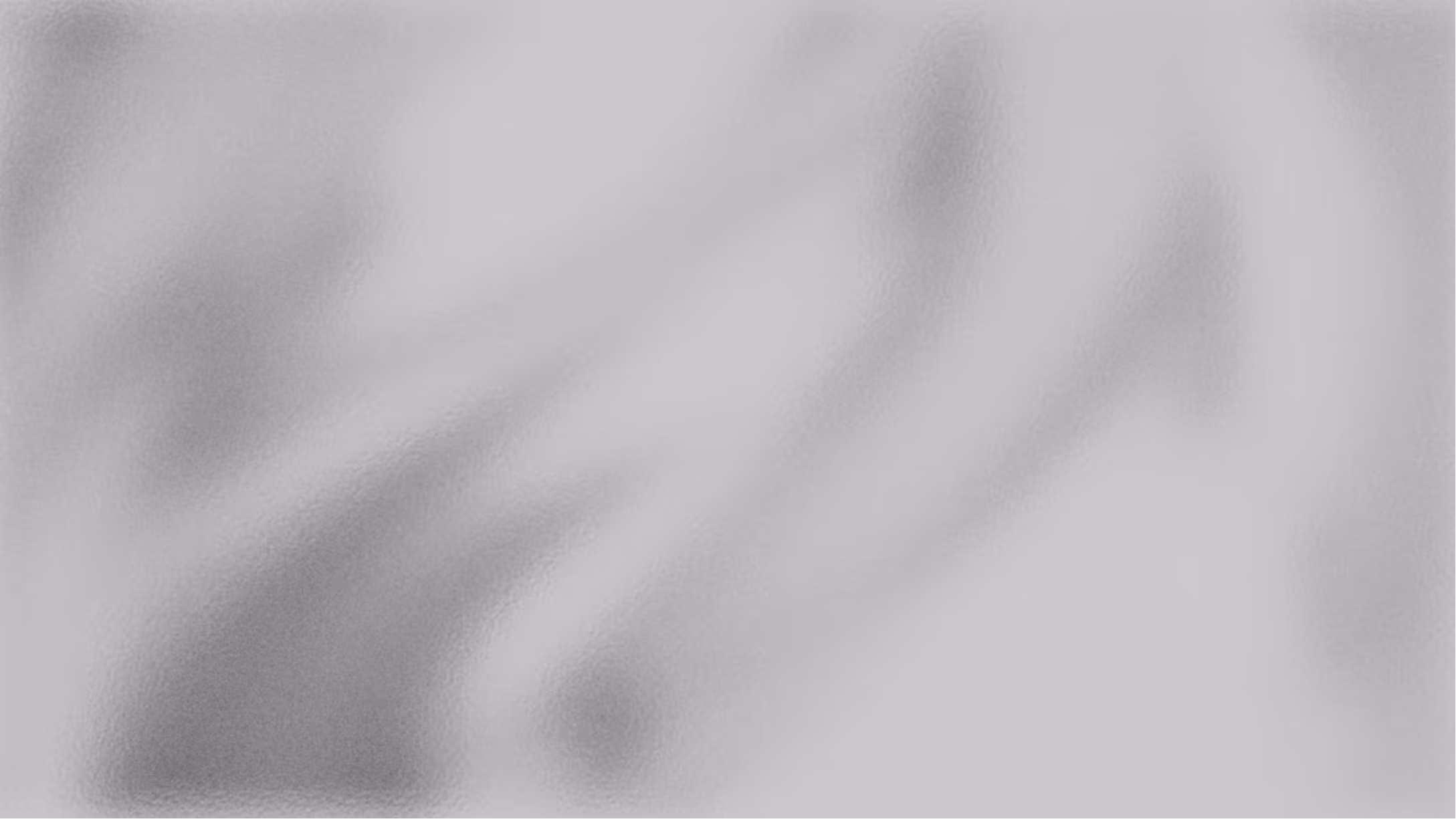 Ein grau-weißes Rechteck, mit hellen und verschwommenen Linien.