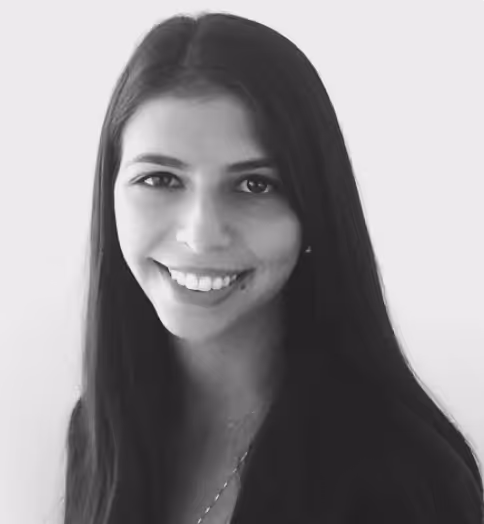 Black and white portrait of a woman with long straight hair smiling at the camera.