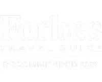 Forbes Travel Guide Recommended 2023 logo in white text on black background.