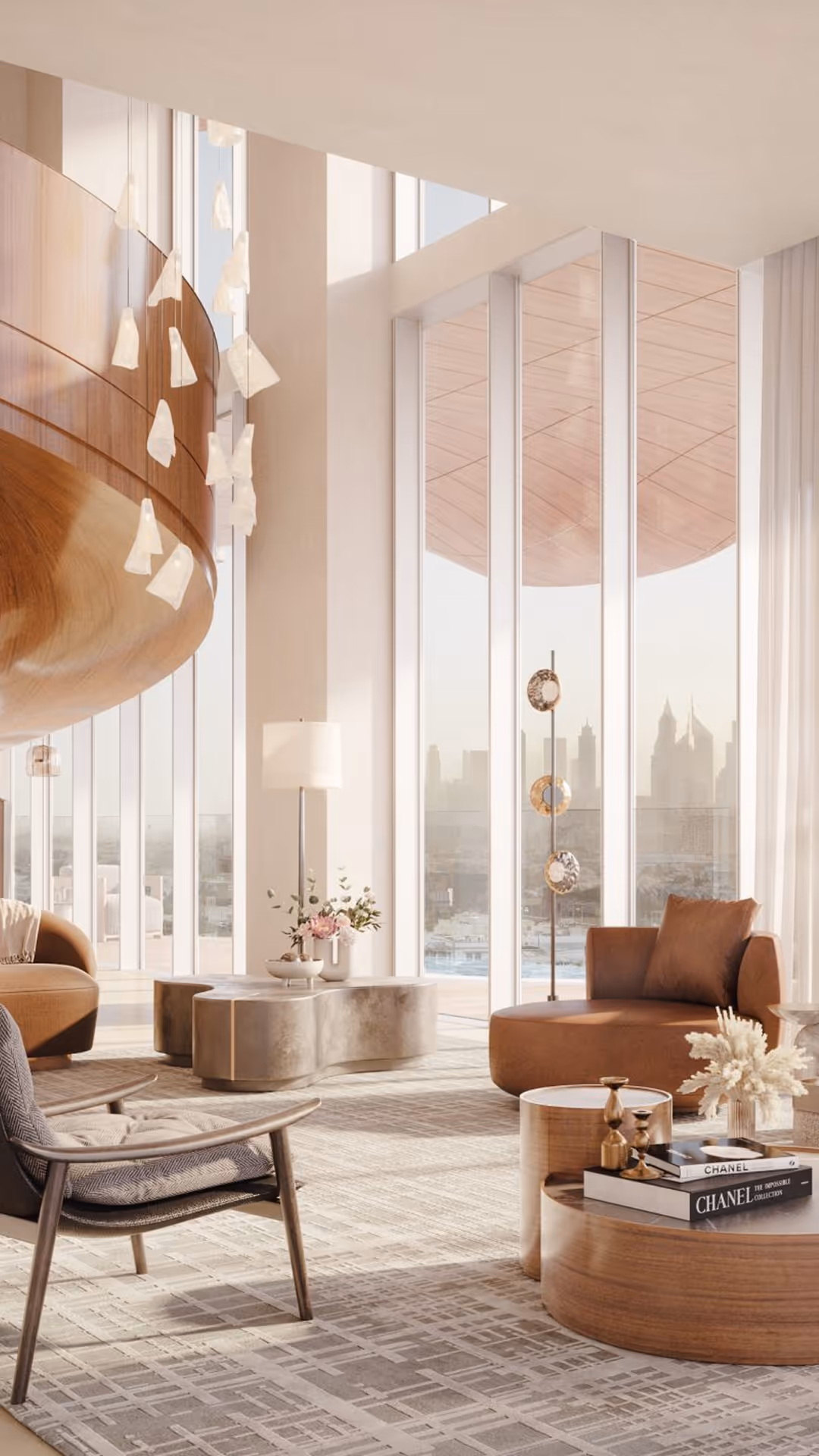 Modern living room with large windows, brown round sofa, armchair, and decorative coffee tables, Mr. C Miami – Coconut Grove, luxury hotel.