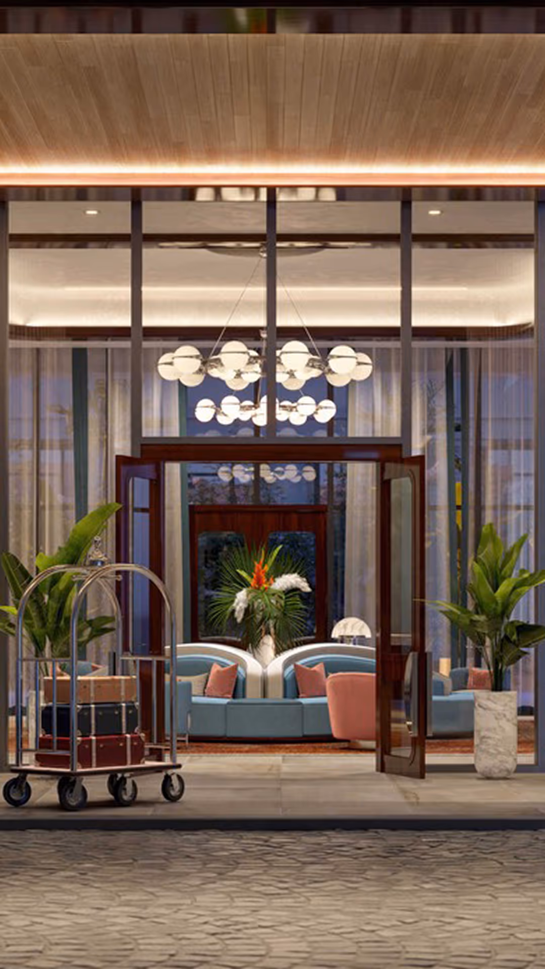 Hotel lobby entrance with glass doors, luggage cart, plants, and modern blue and pink seating inside
, Mr. C Miami – Coconut Grove, luxury hotel.