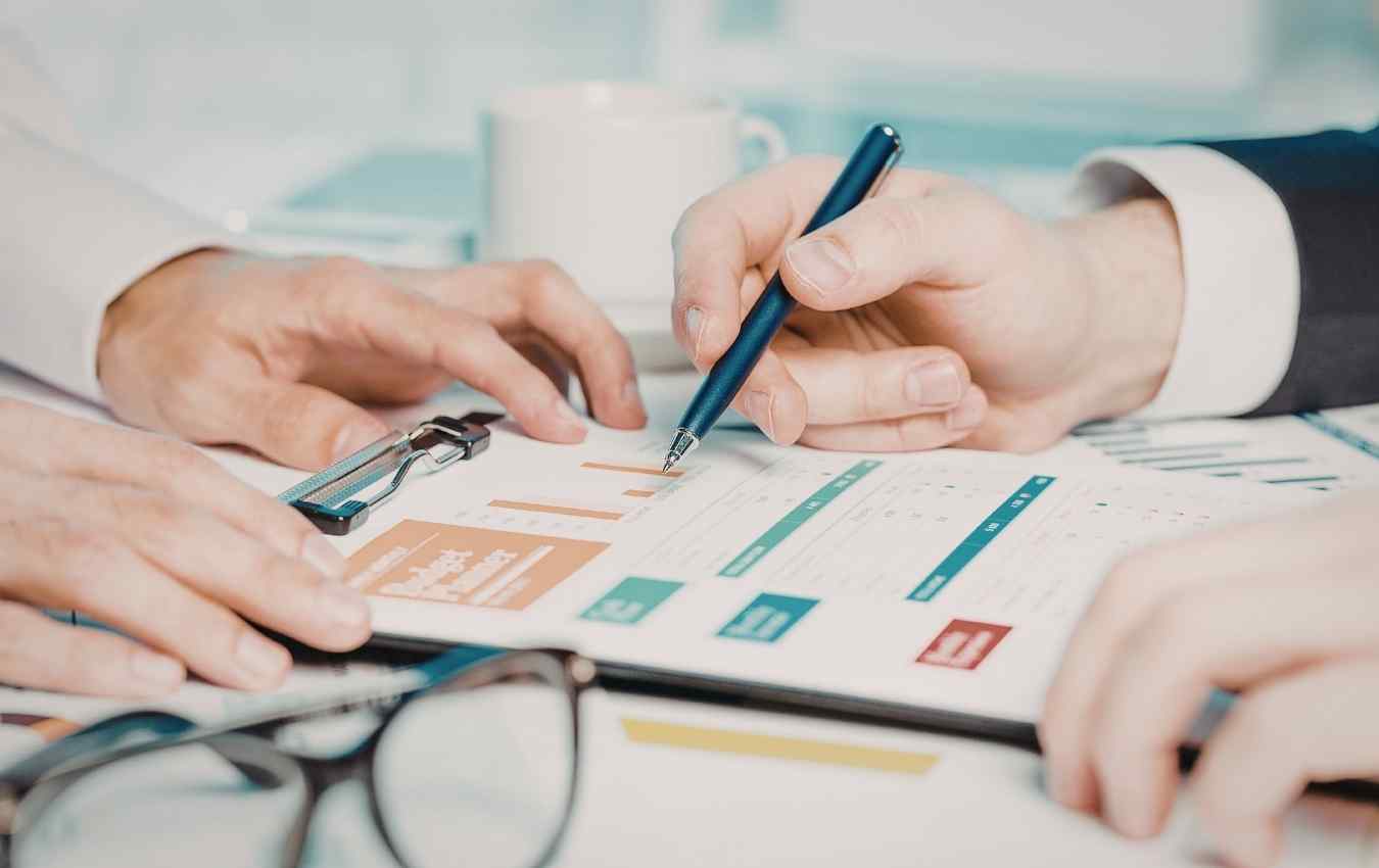 image of financial reports being reviewed