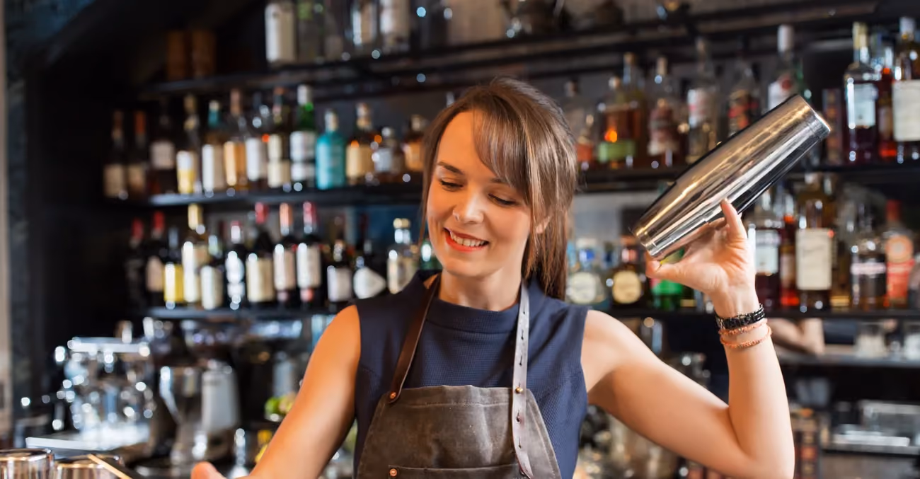 Bartender shaking a cocktail at a hotel bar.
