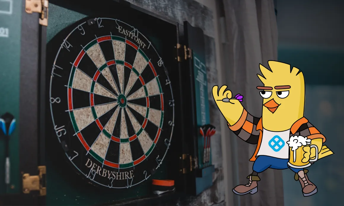 Dartboard mounted on a wall with an animated yellow bird character holding a dart and a mug of beer.
