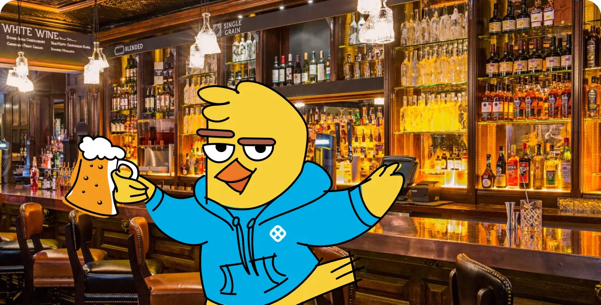Cartoon yellow bird wearing a blue hoodie holding a foamy beer mug in a cozy pub with wooden chairs and shelves filled with bottles.