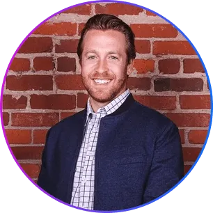 Headshot of Trevor Stuartt in front of a brick wall.