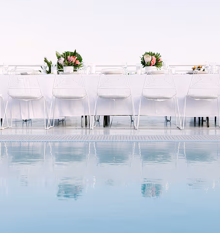 Elegant dining table set for an event on the Pool Deck, reflected in the water. Mr. C Miami – Coconut Grove.
