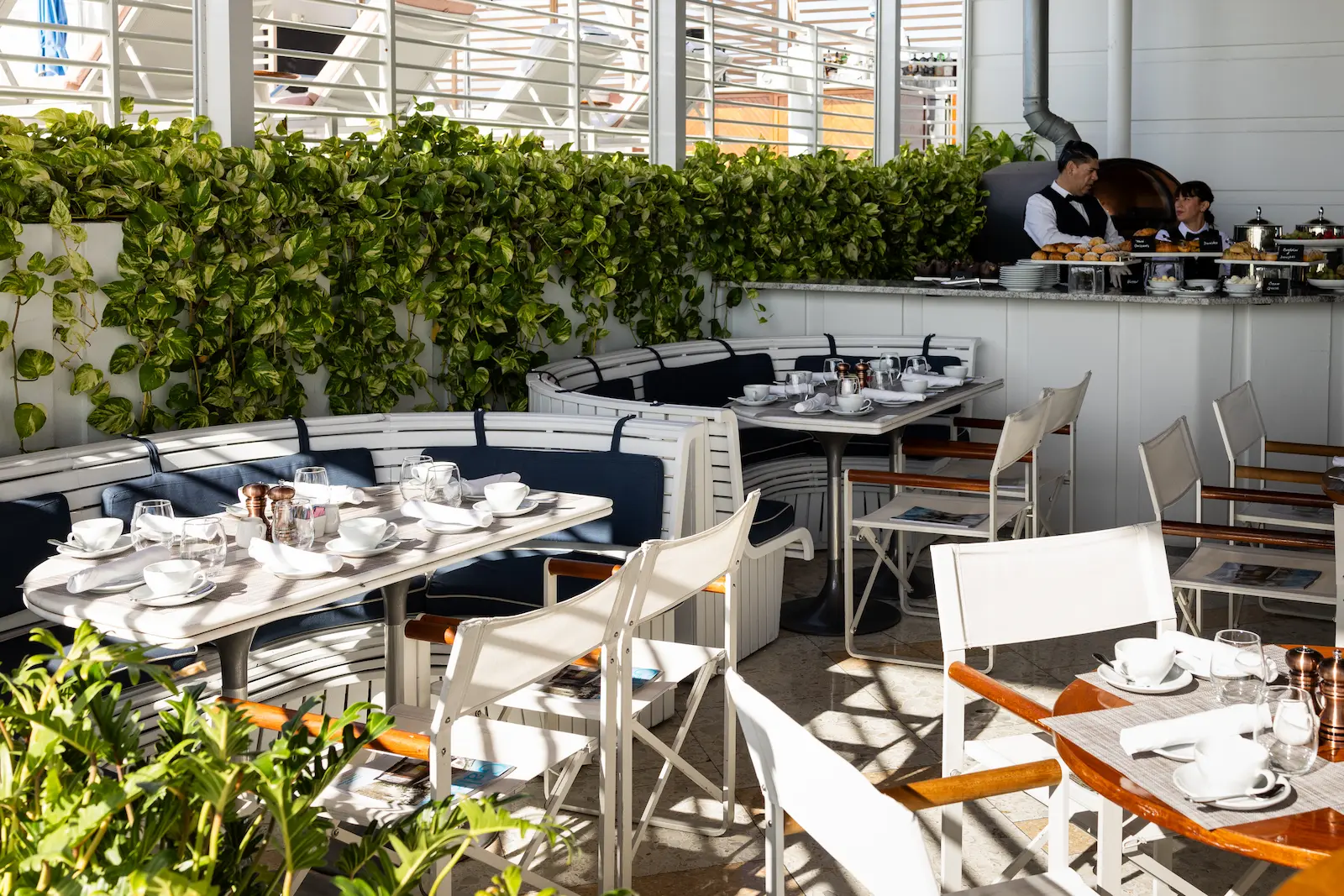 Outdoor dining terrace at Bellini with lush greenery. Mr. C Miami – Coconut Grove, a luxury hotel.