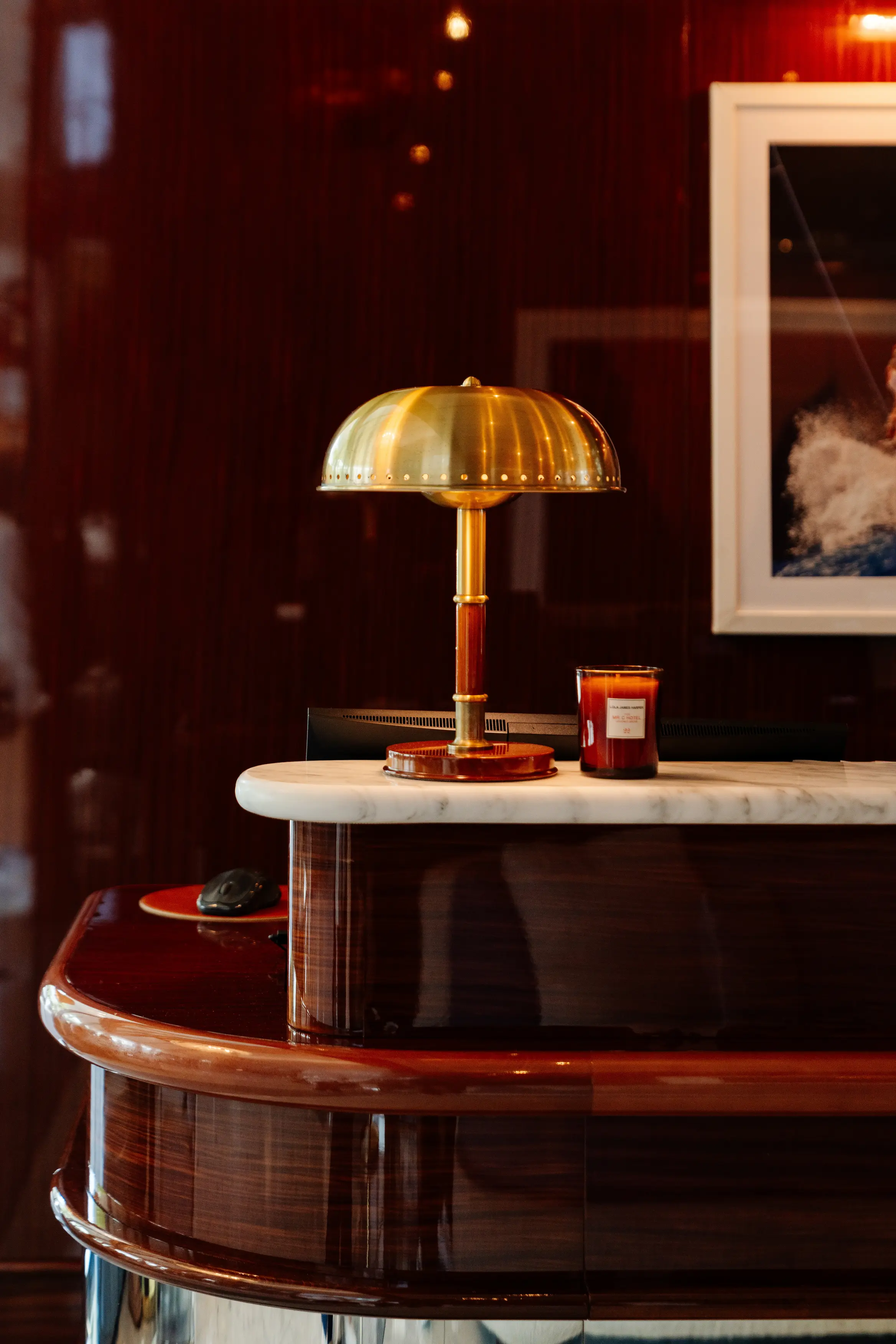 Elegant brass desk lamp on a polished marble counter, Mr. C Miami – Coconut Grove, luxury hotel.