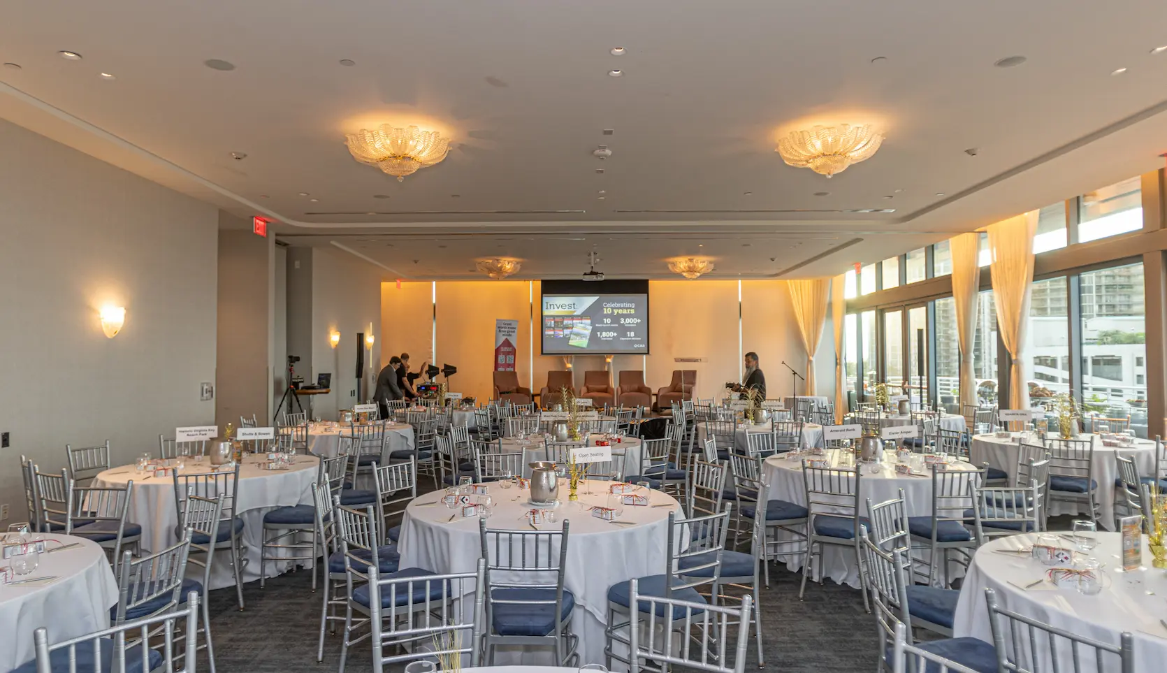Starlight Ballroom prepared for a large event with numerous round tables and white chairs. Mr. C Miami – Coconut Grove.