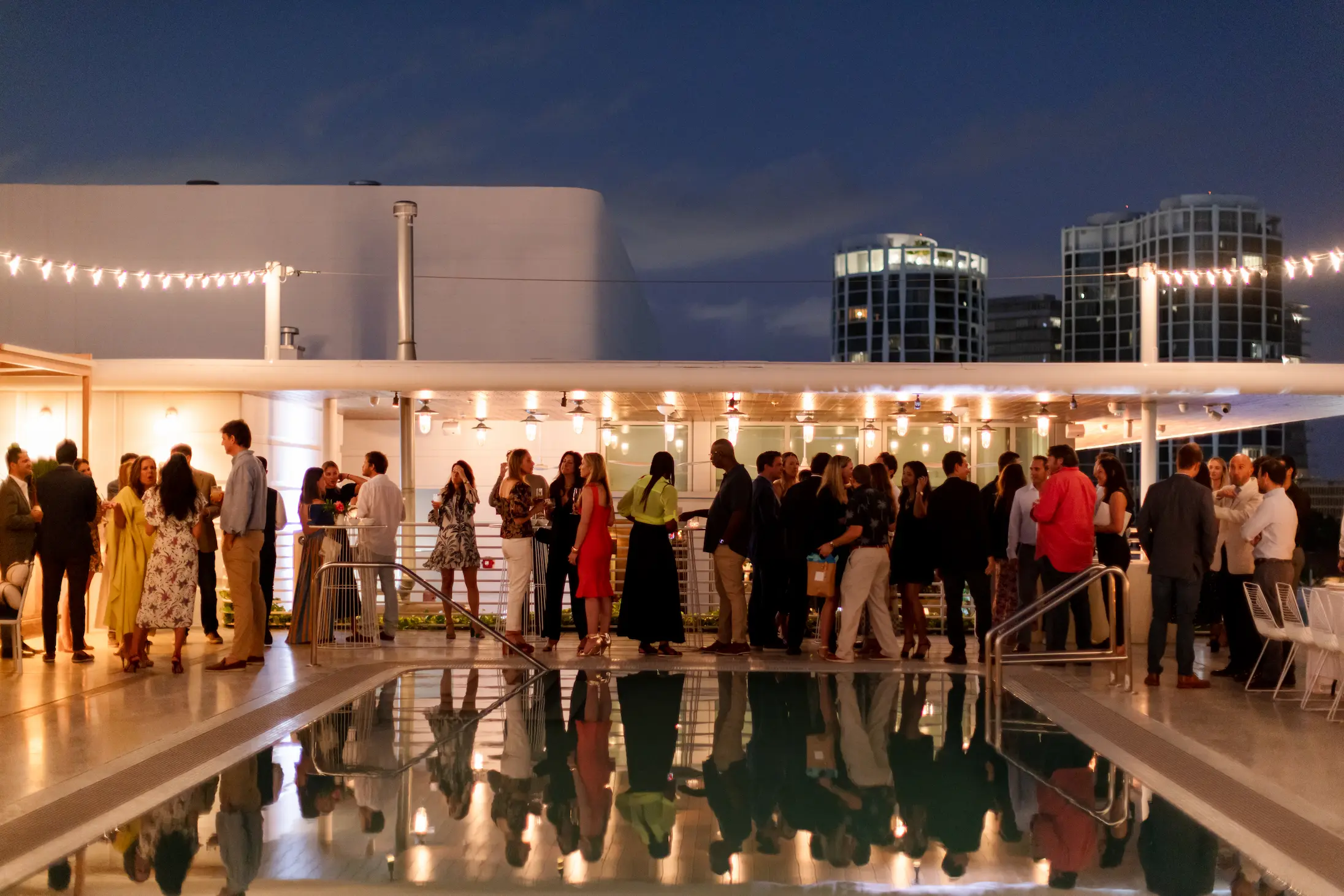 Evening social gathering at the illuminated Pool Deck. Mr. C Miami – Coconut Grove, luxury hotel.