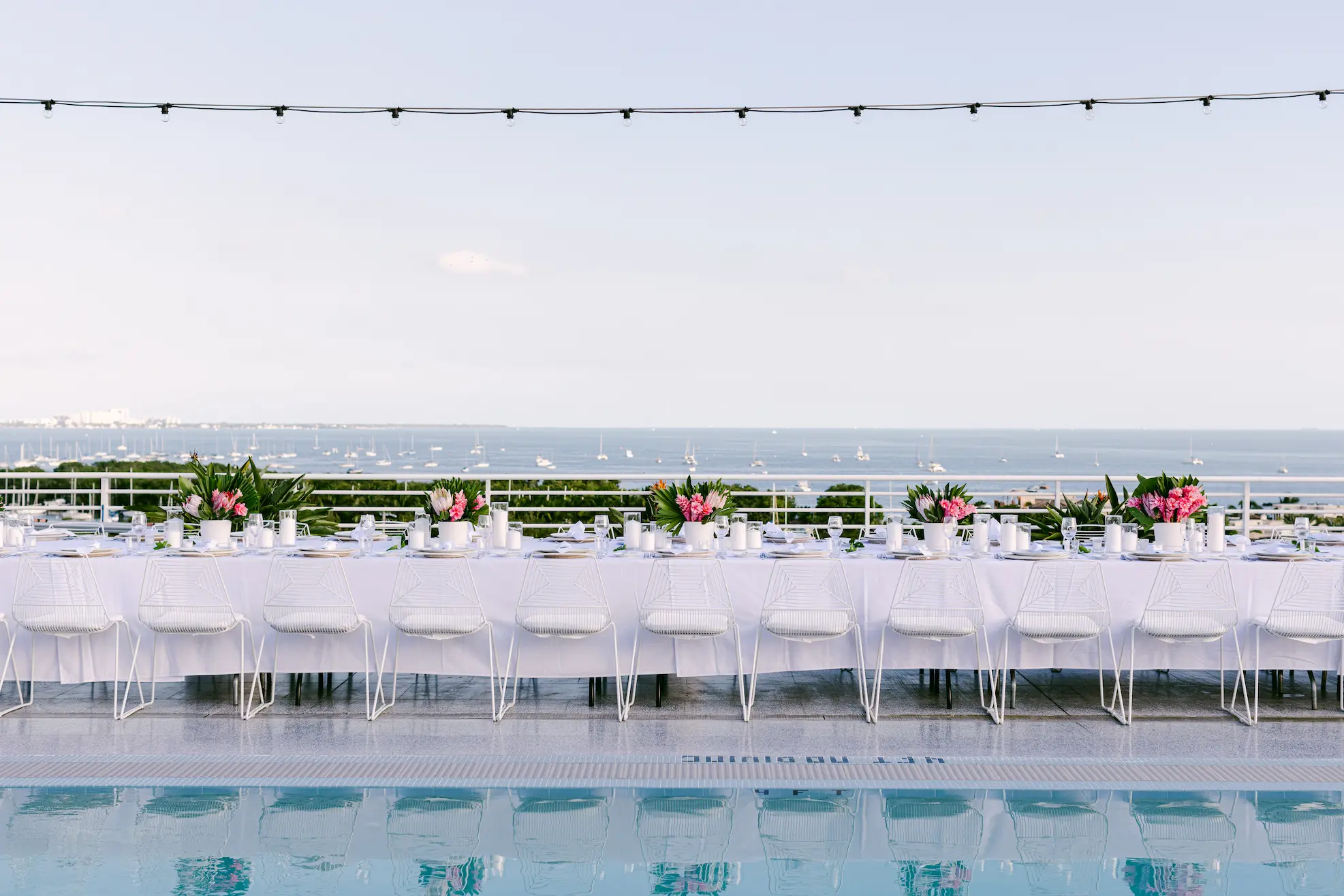 Long dining table arranged for a special occasion on the Pool Deck. Mr. C Miami – Coconut Grove.