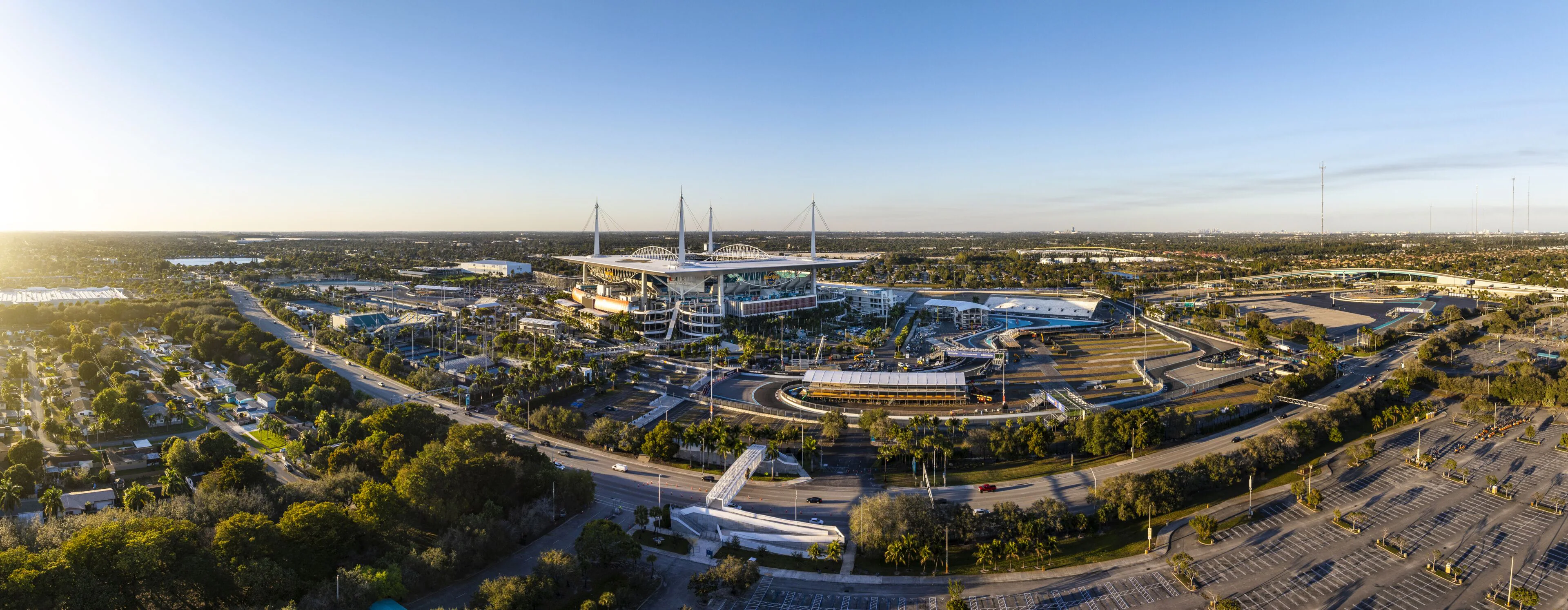 Hard Rock Stadium with teal seats, large scoreboard, and dolphin logo on football field , Mr. C Miami – Coconut Grove, luxury hotel.
