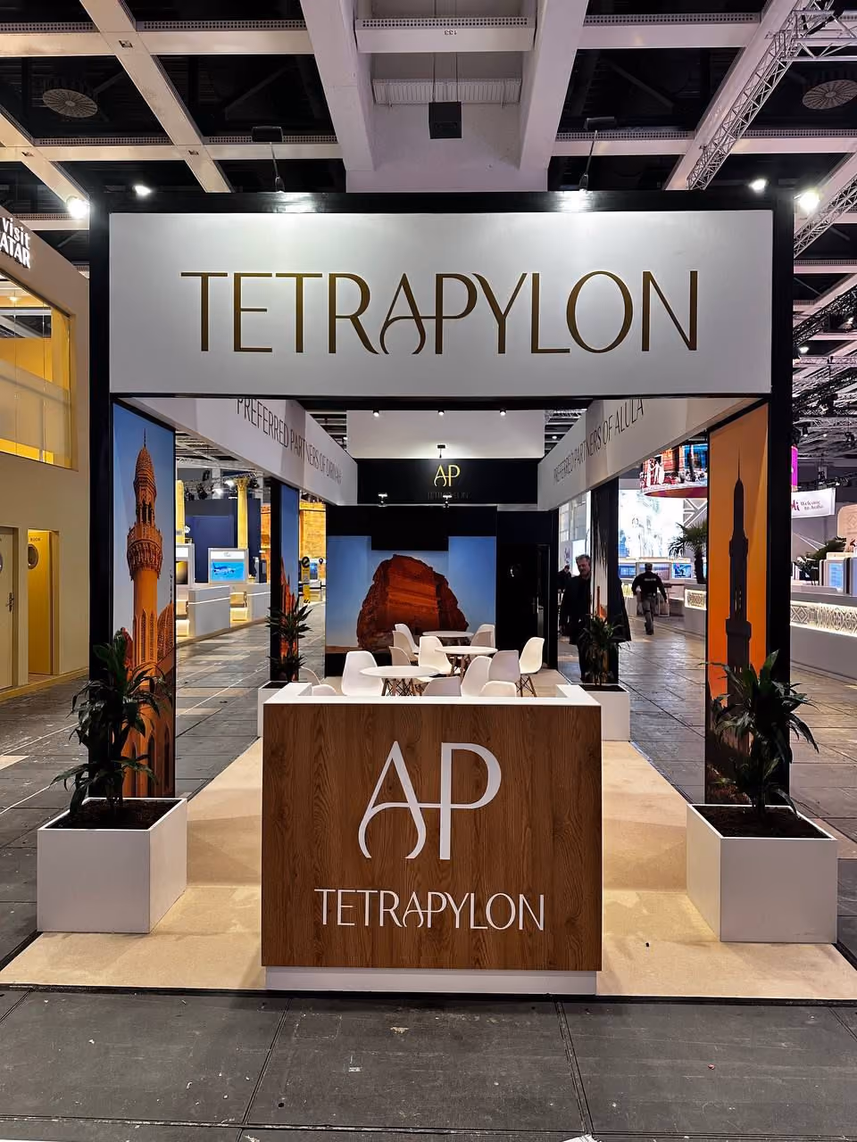 Tetrapylon exhibition stand design with branded reception counter