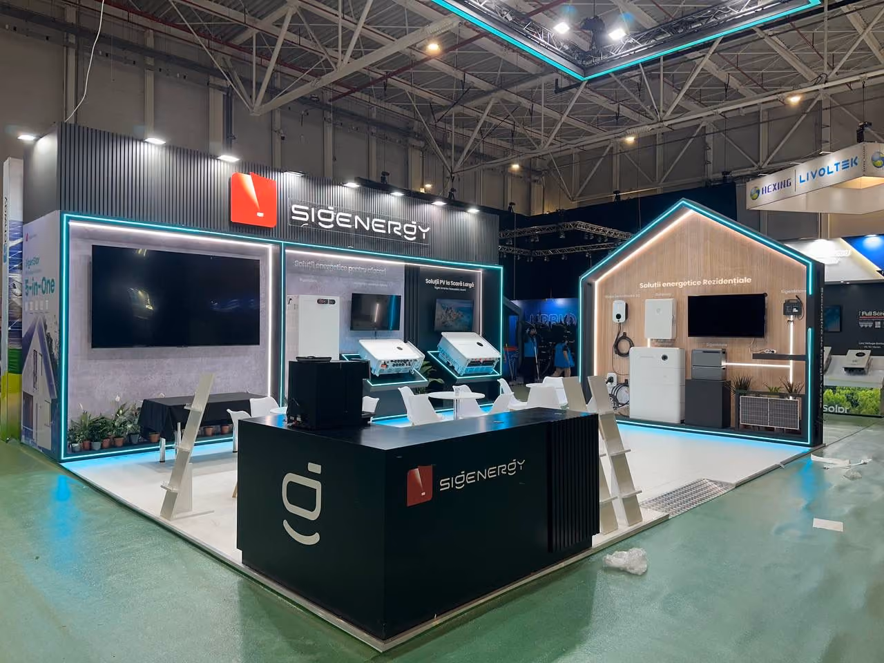 Sigenergy exhibition stand with illuminated product displays, digital screens, and open seating area