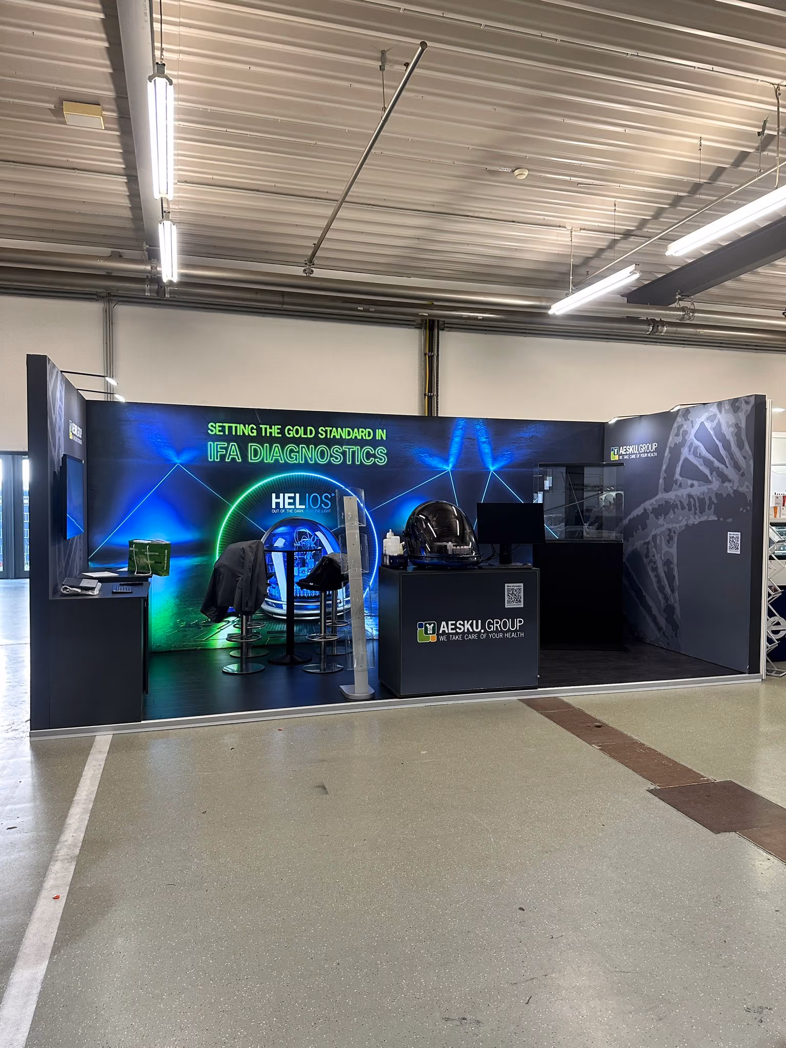 Aescu Group exhibition stand design with blue ambient lighting