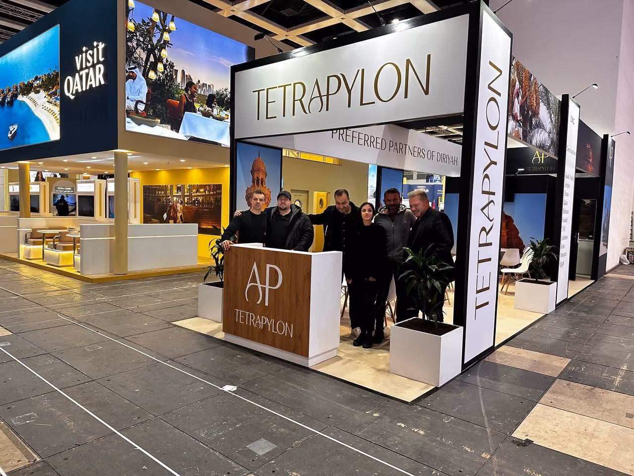 Tetrapylon exhibition stand design with branded reception counter