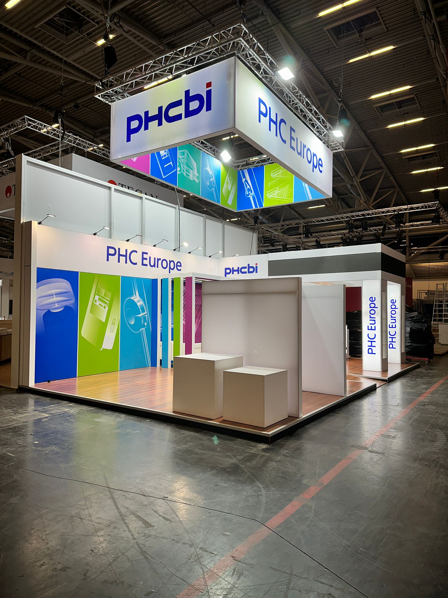 PHC Europe exhibition stand with product displays and branded graphics