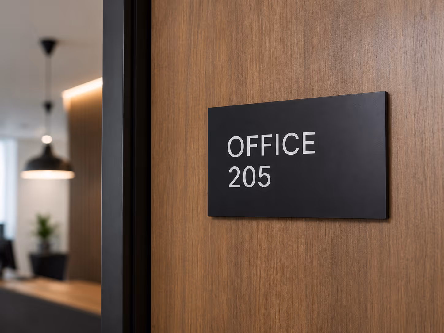 Matt black door sign for Merrion Buildings