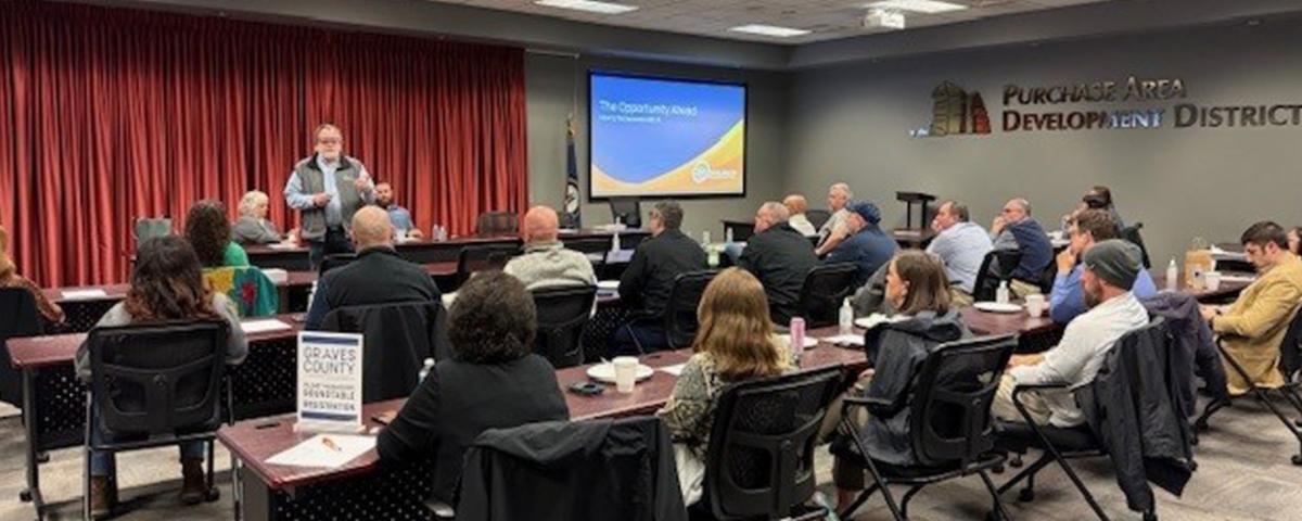 A presenter addressing attendees at a GCED Plant Managers Roundtable Breakfast in Mayfield