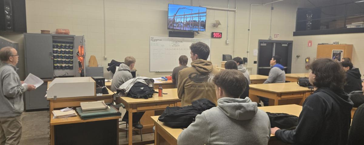 ATC advanced carpentry students watching a construction industry presentation during a Power in Partnership classroom visit