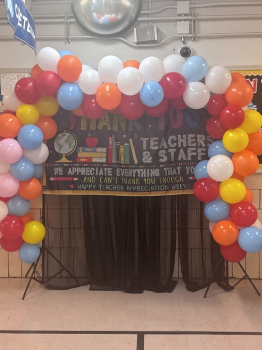 Colorful balloon arch framing a Teacher Appreciation Week banner
