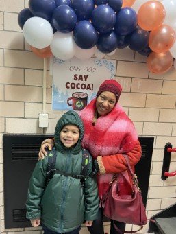 Student and adult posing at PS 300 Say Cocoa winter event