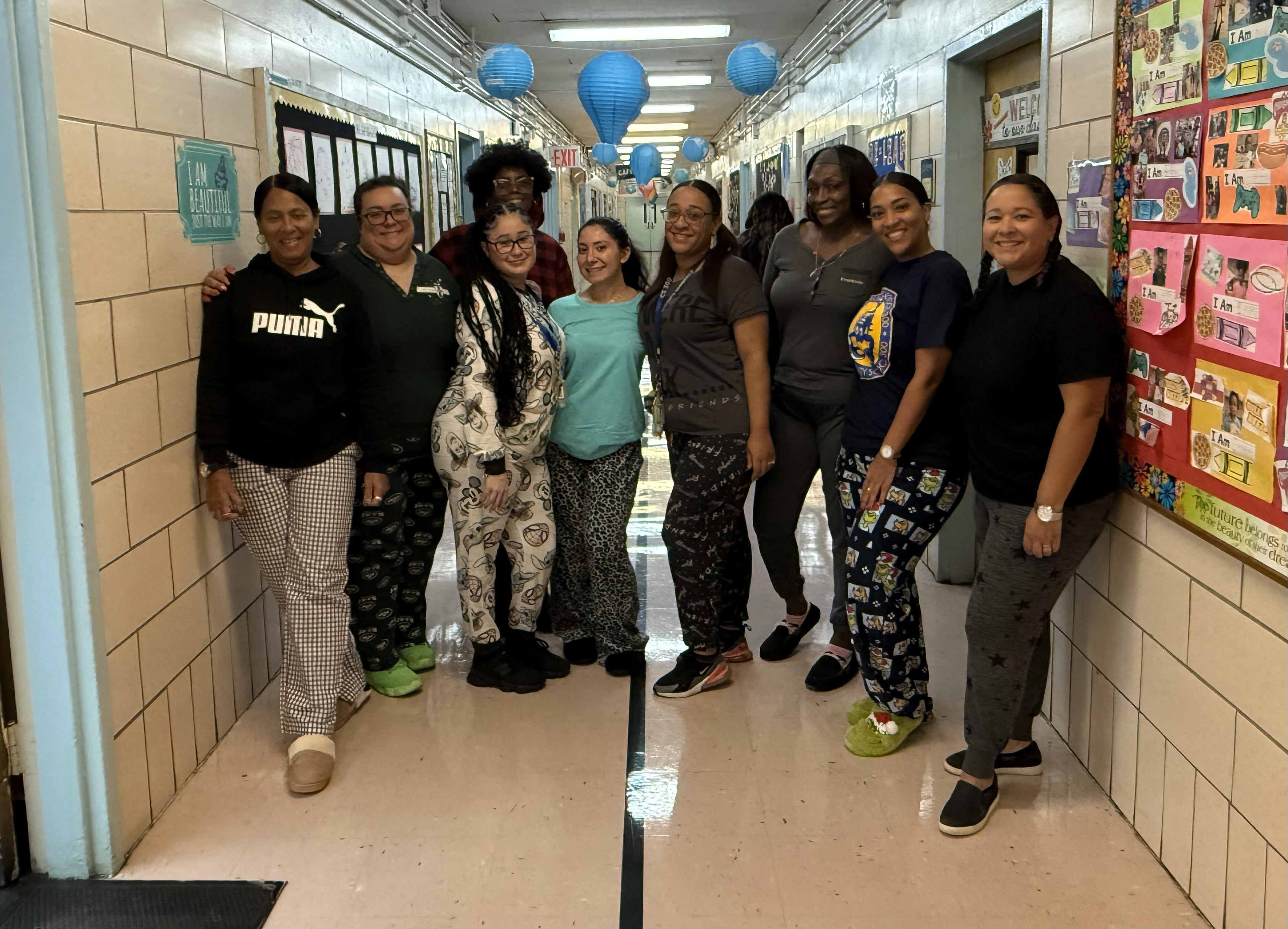 School staff posing together in pajamas during spirit day