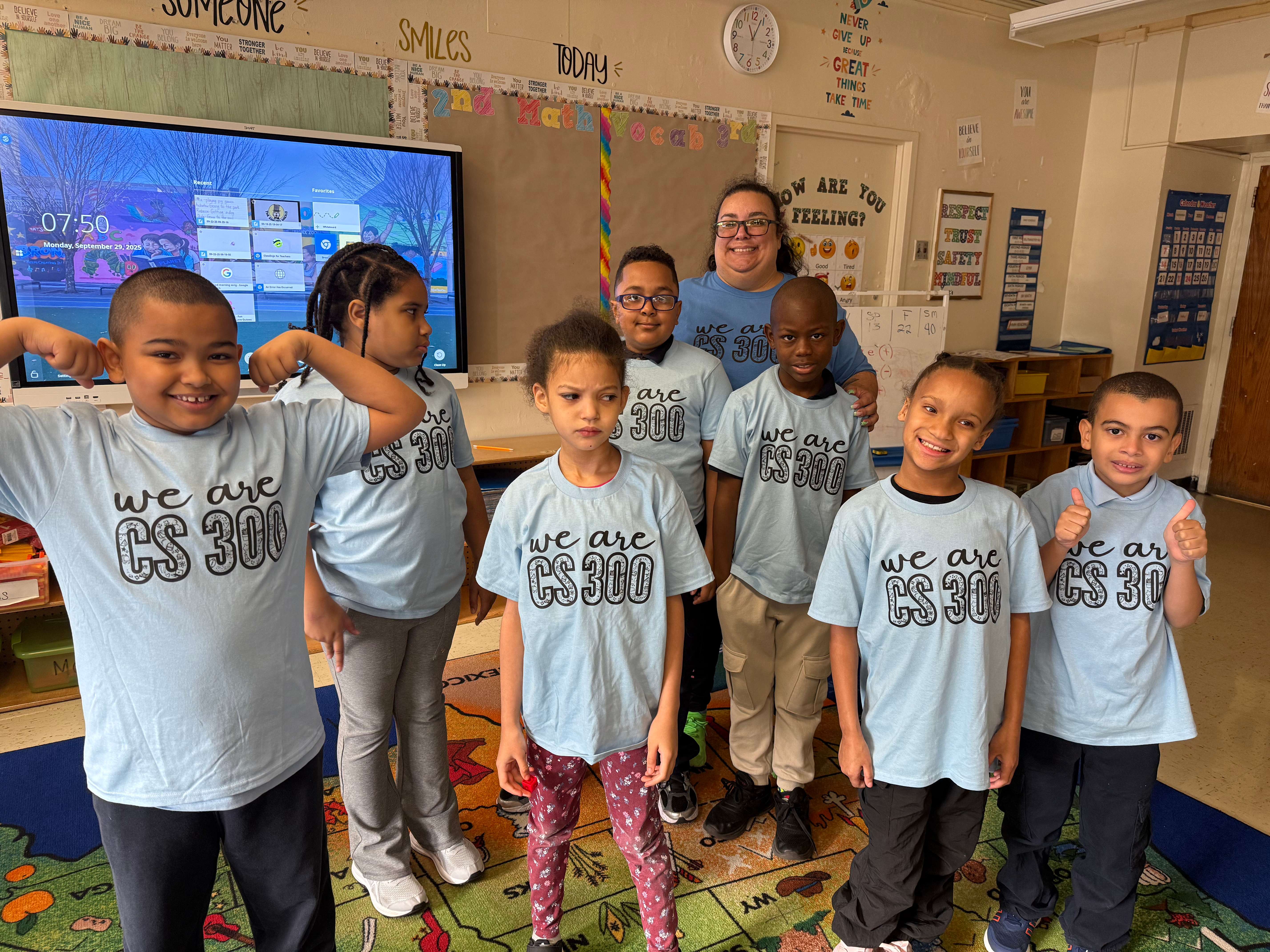 Teacher and students wearing We Are CS 300 school spirit shirts