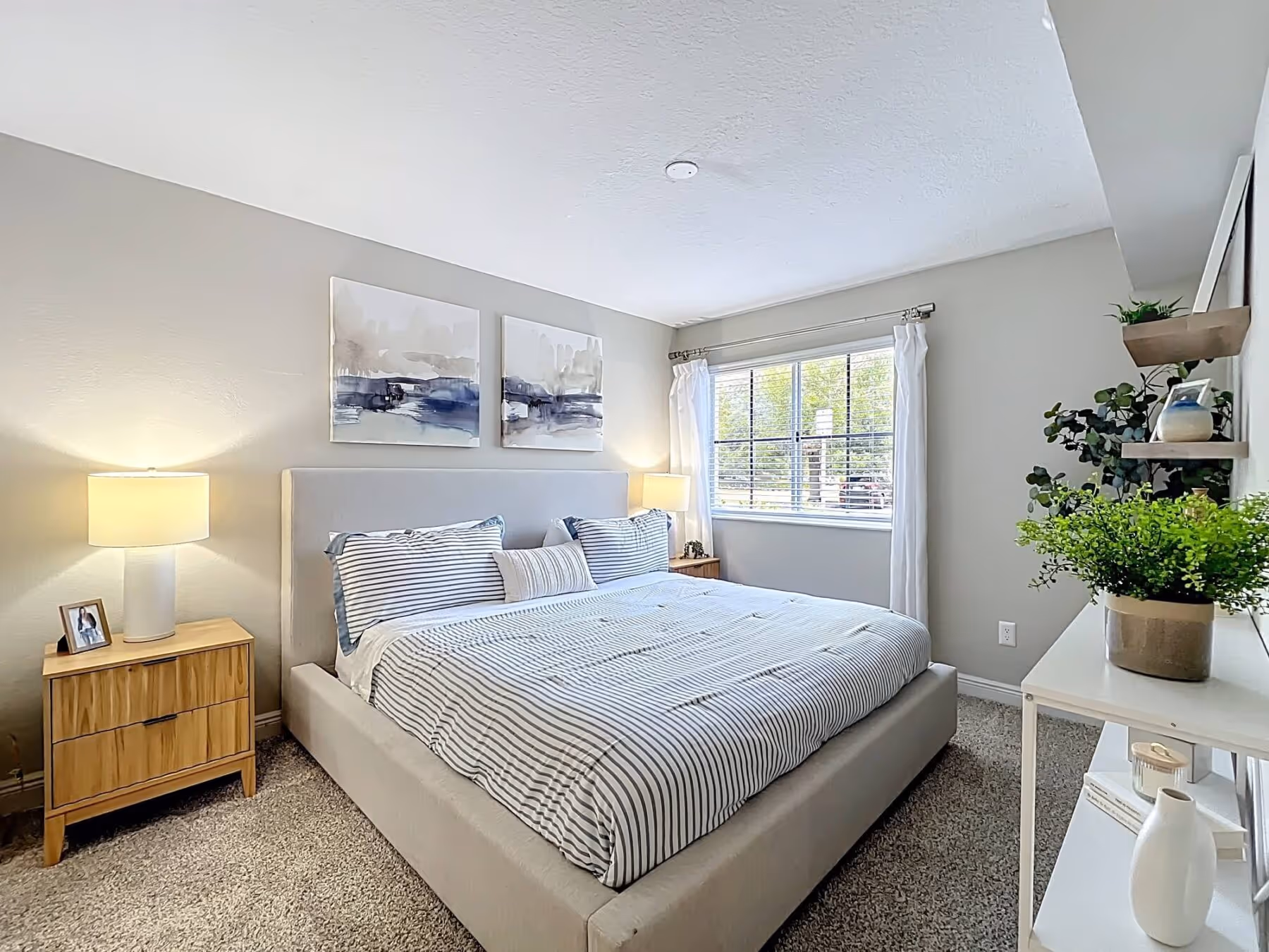 Furnished bedroom with staged bed and nightstands