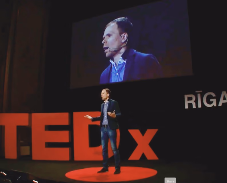 Tom Crosshill speaking on a TEDx stage