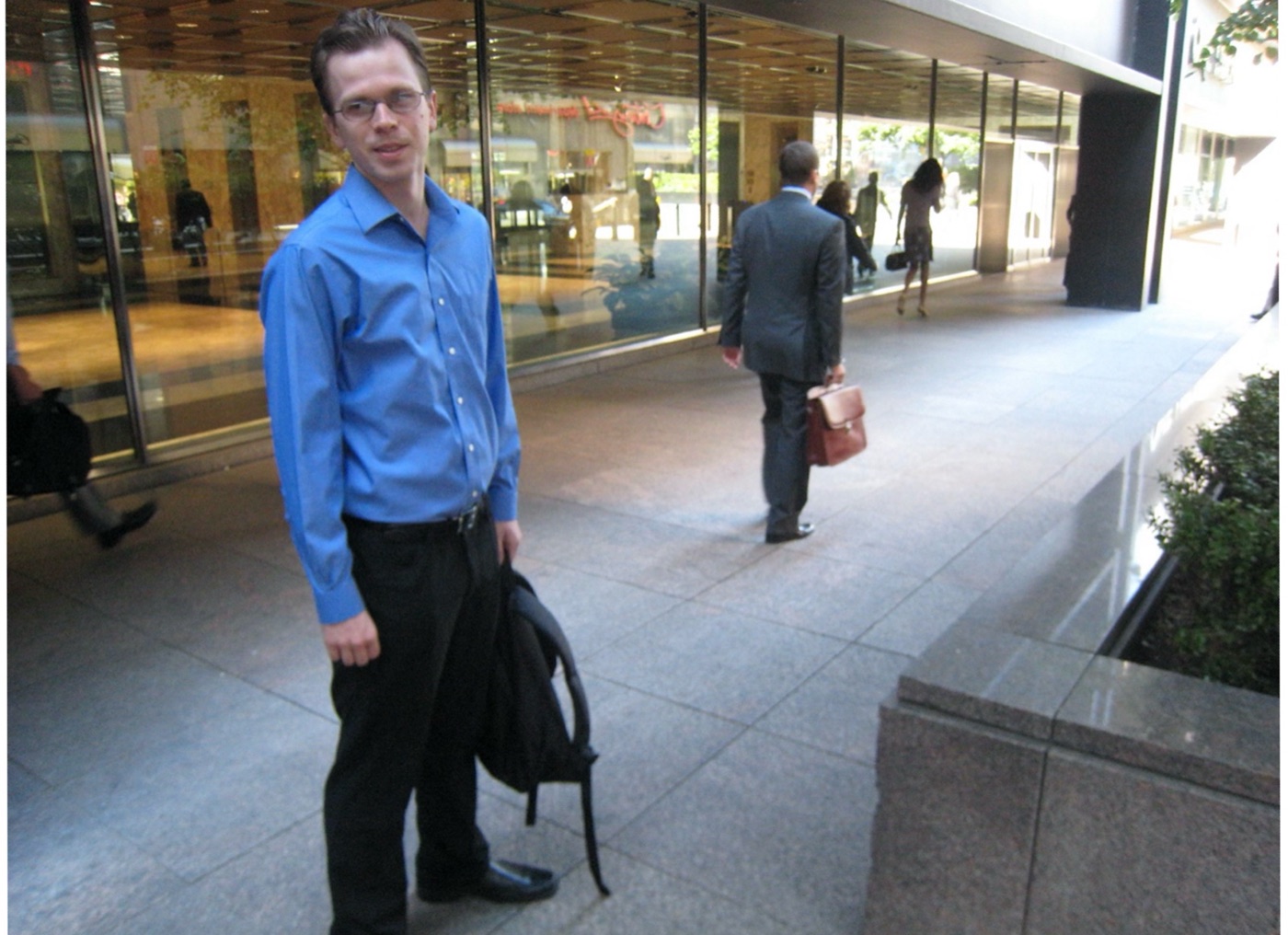 Tom Crosshill walking through a New York financial district street