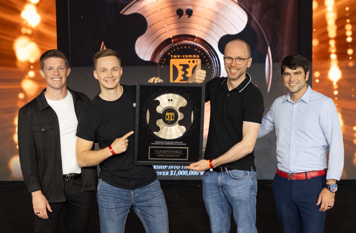 Tom Crosshill and three colleagues holding an award trophy