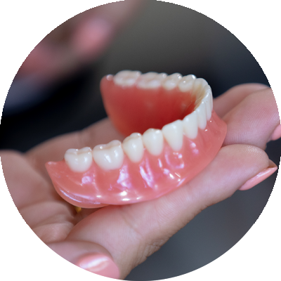 denture in hand