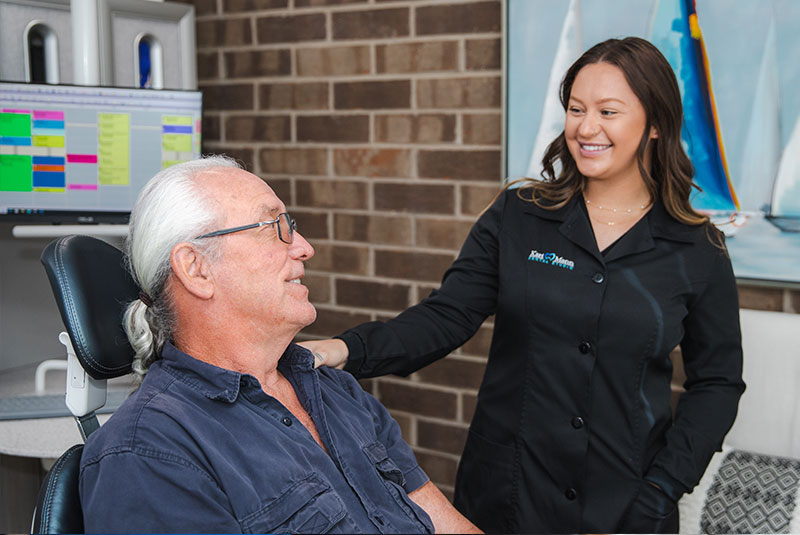 patient and staff member going over dental procedure information within the dental practice