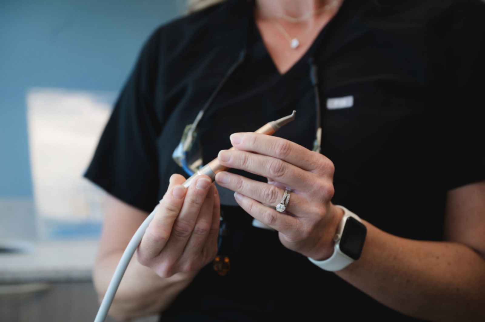 Dentist demonstrating dental tool technique during gum contouring procedure