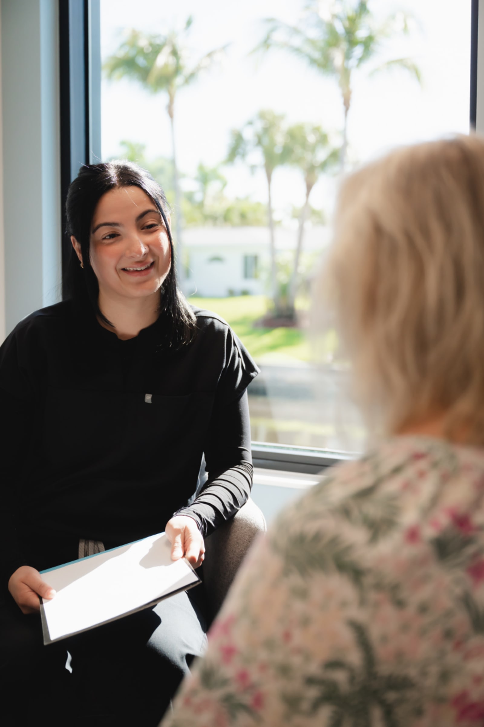 Kari Mann consulting with a patient about cosmetic dental treatment options