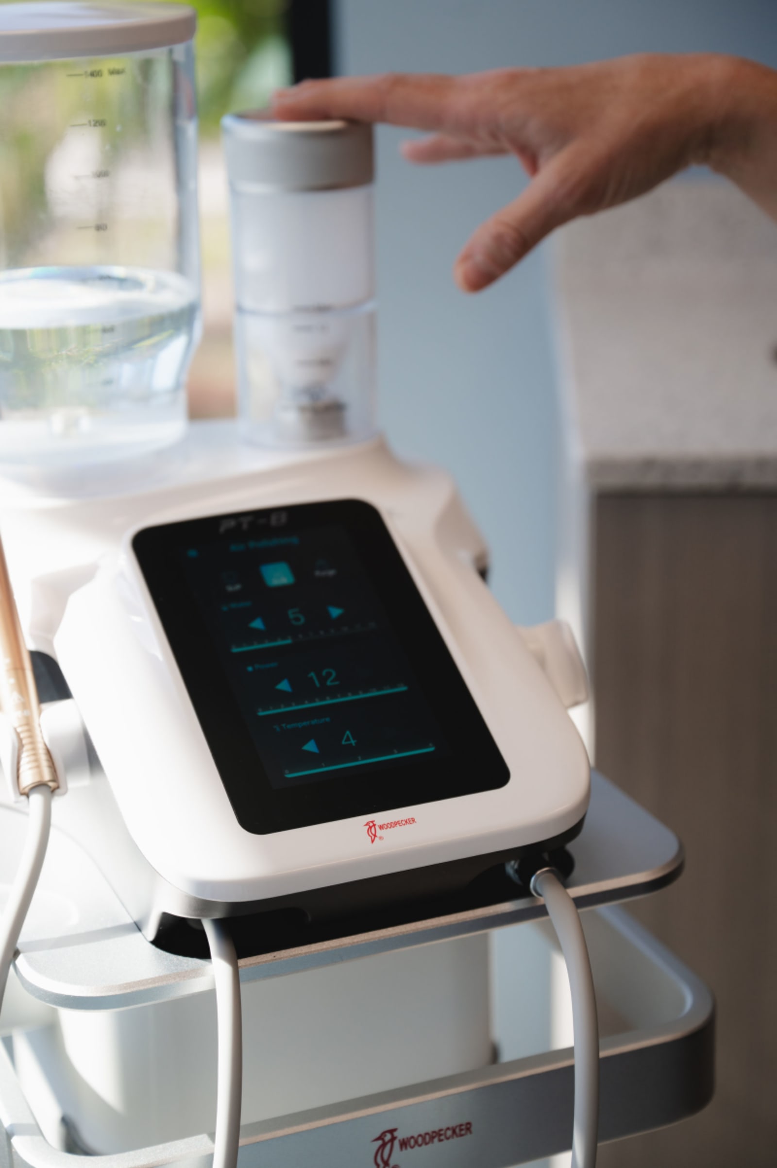Dental professional demonstrating digital treatment planning on a tablet with patient