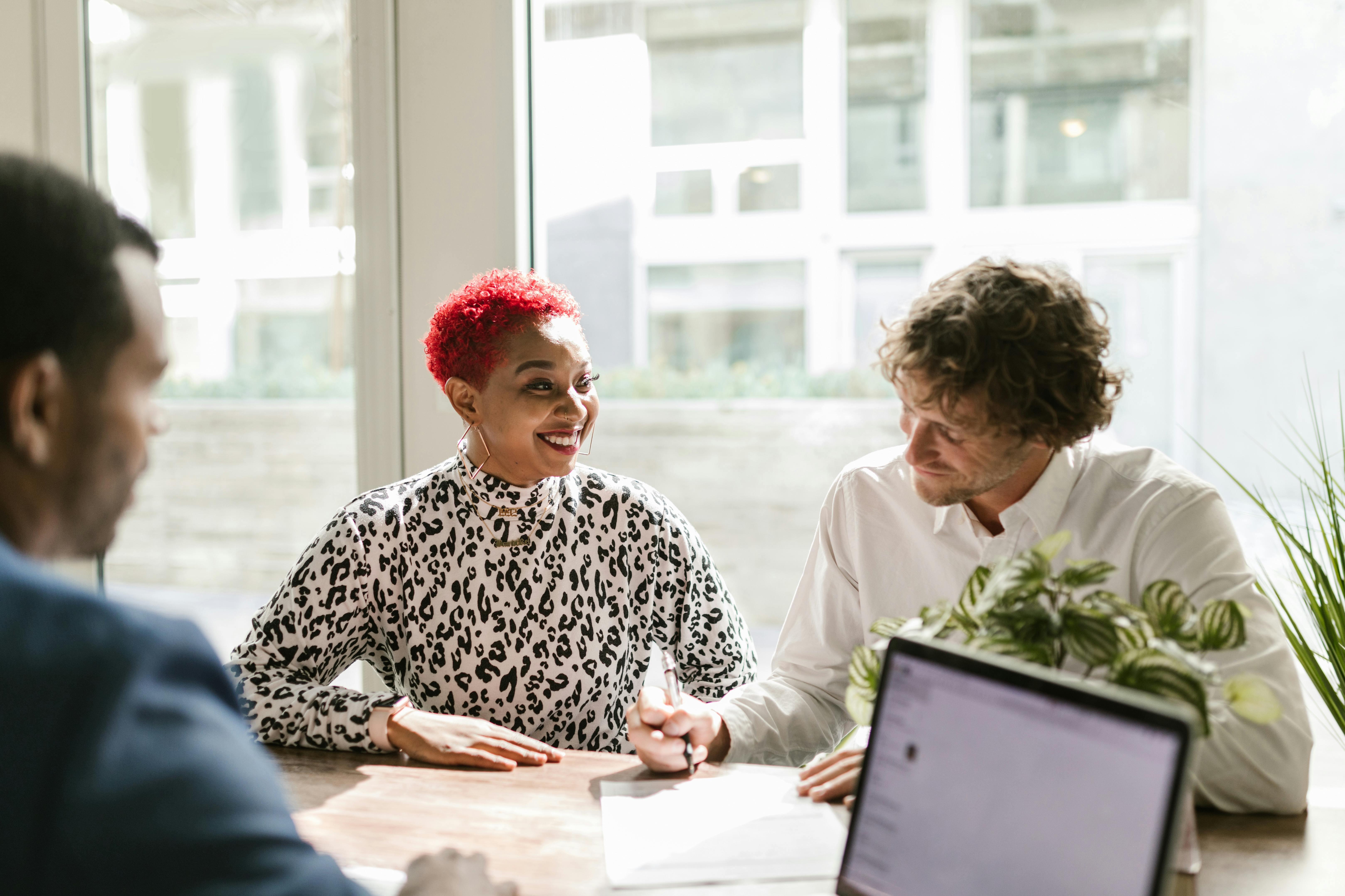 Clients sitting at a table during a consultation meeting with a financial advisor.