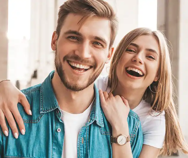 Smiling adult couple at an orthodontic consultation