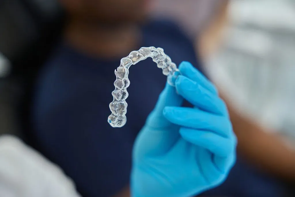 Orthodontic professional holding a dental model