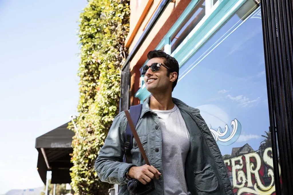 Man smiling confidently outdoors