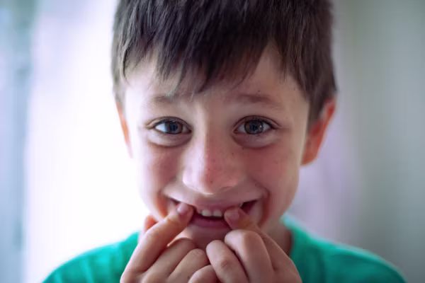 Young boy smiling during orthodontic treatment