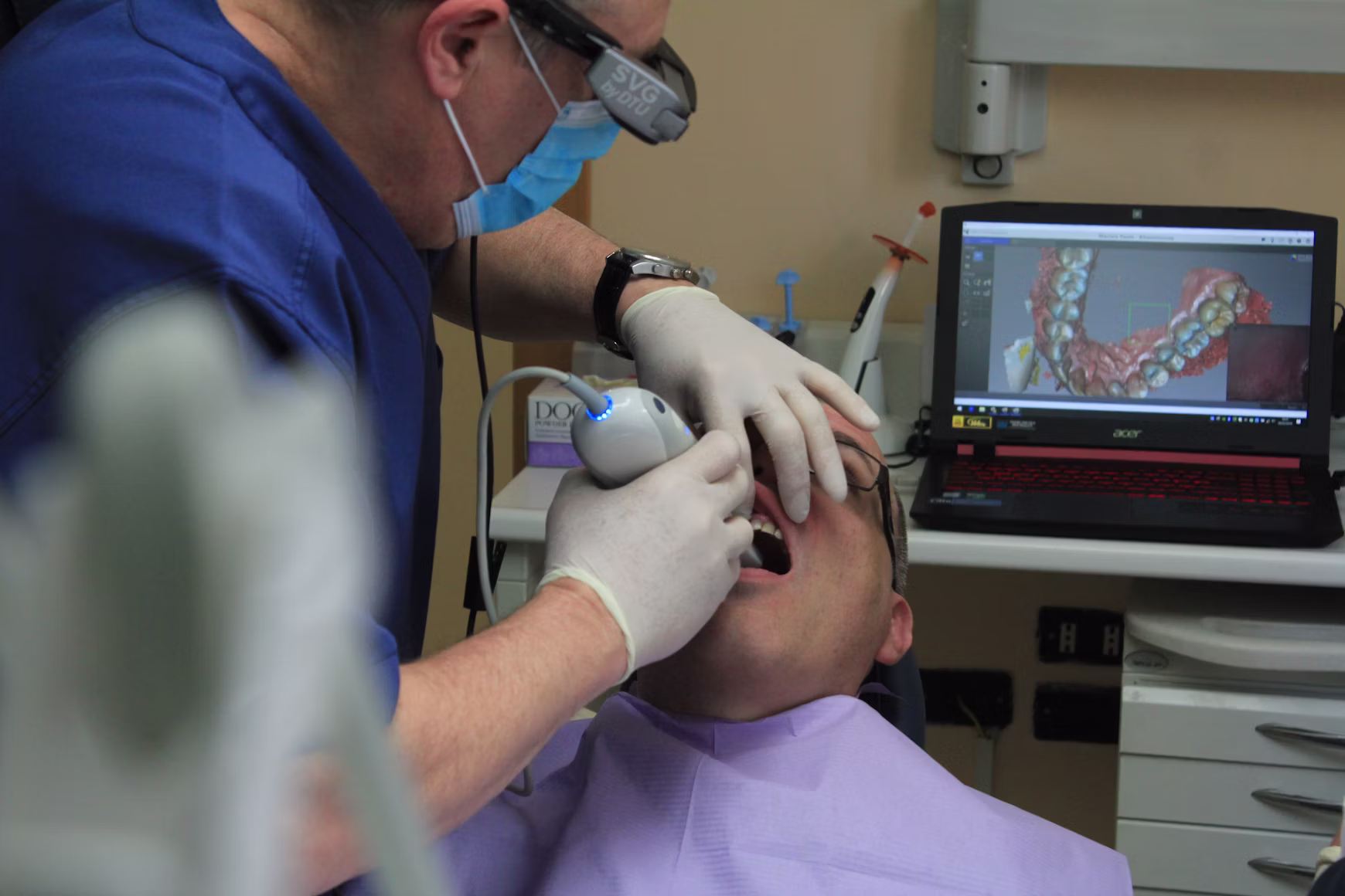 Child receiving a digital orthodontic scan during treatment evaluation