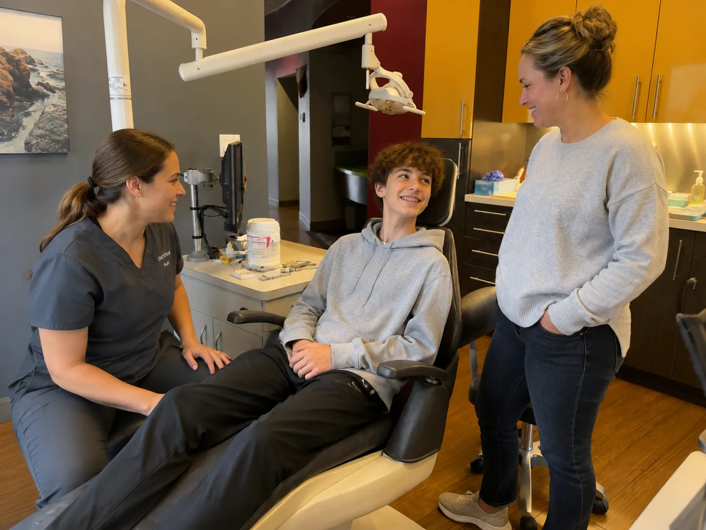 Teen patient during an airway orthodontic evaluation with a team member and parent