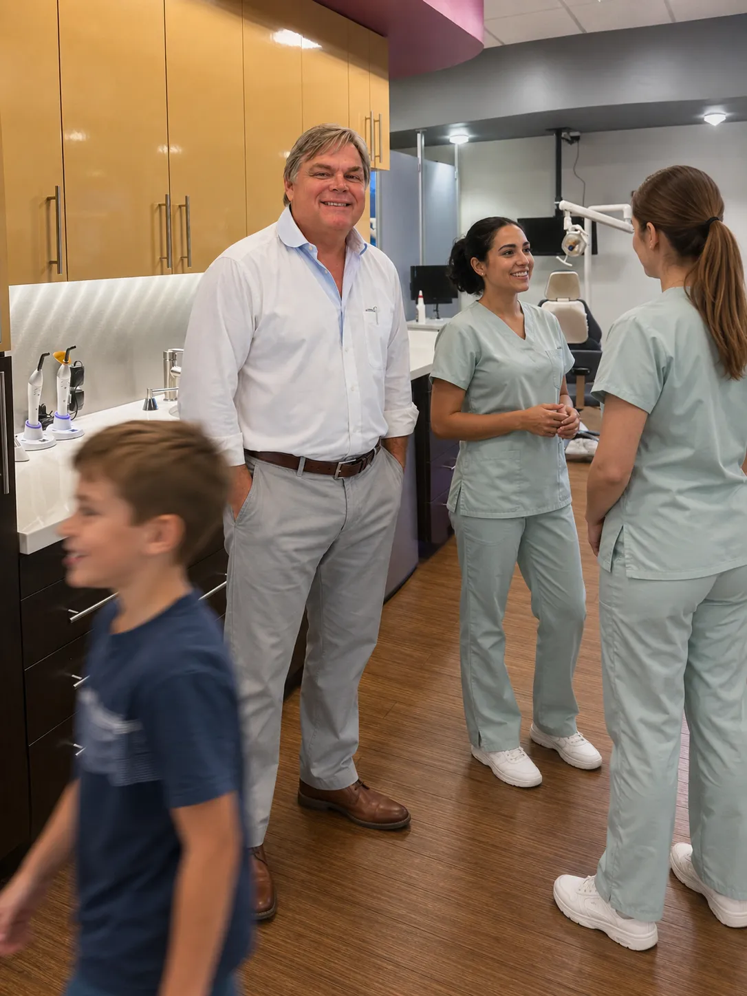 Dr. Kendrick with teen patients in the treatment area at Kendrick Orthodontics in Kissimmee, FL