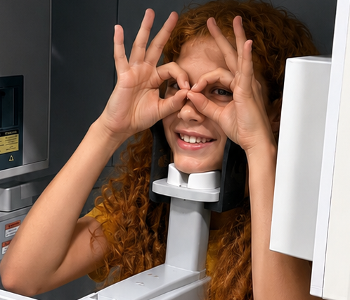 Child patient smiling during a CBCT scan at Kendrick Orthodontics in Kissimmee, FL