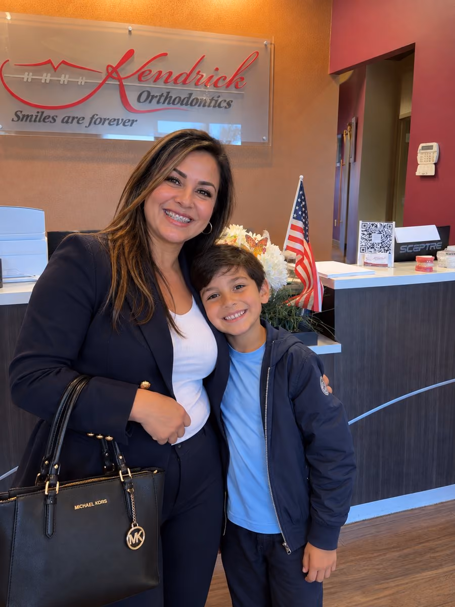 Smiling orthodontic patient with braces and her son at Kendrick Orthodontics in Kissimmee, FL