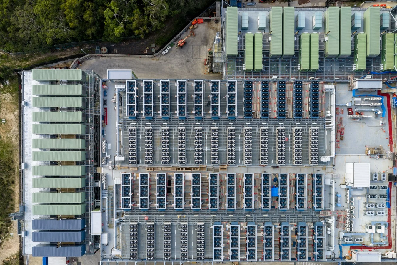 Aerial view of a data centre complex with rooftop plant and solar panels