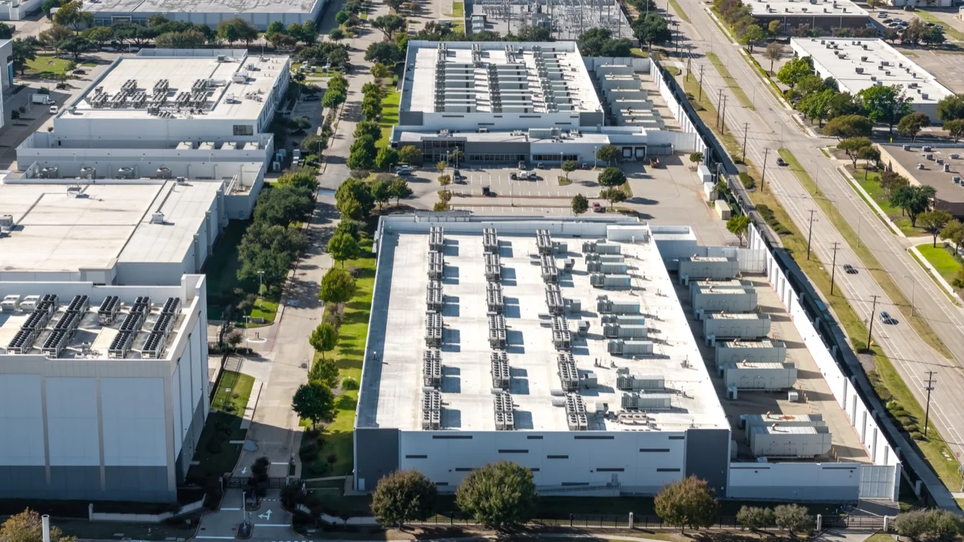 Aerial view of a large data centre campus with rooftop cooling arrays